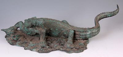 Lot 468 - A BRONZE SCULPTURE OF A CROCODILE having green...