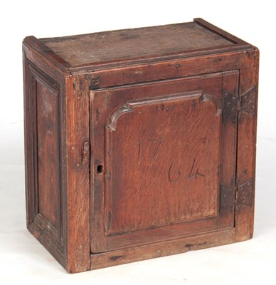 Lot 883 - AN 18TH CENTURY OAK SPICE CUPBOARD with raised...