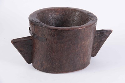 Lot 597 - AN EARLY CHIP CARVED WALNUT MORTAR with angled...