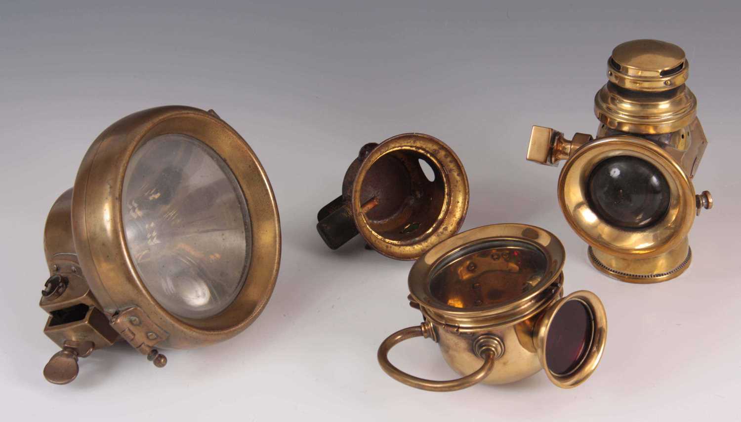 Lot 293 - A SELECTION OF FOUR VINTAGE BRASS CAR LAMPS to...