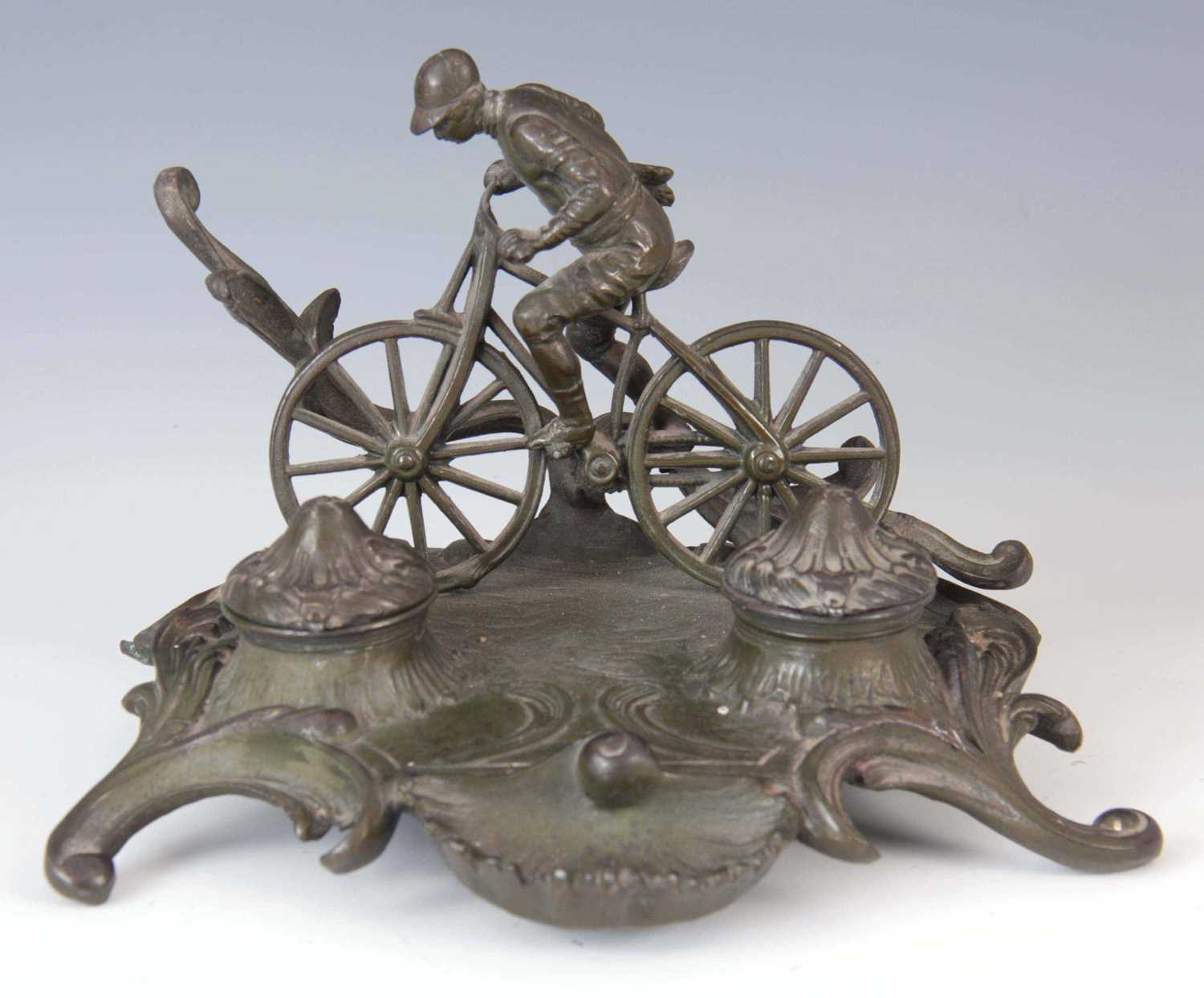 Lot 307 - AN EARLY 20TH CENTURY PATINATED METAL INKSTAND...