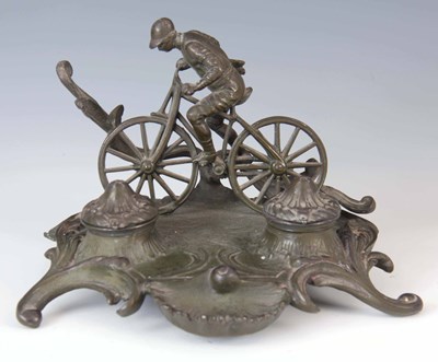 Lot 307 - AN EARLY 20TH CENTURY PATINATED METAL INKSTAND...