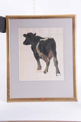 Lot 355 - A 20TH CENTURY OIL ON PAPER DEPICTING A COW...