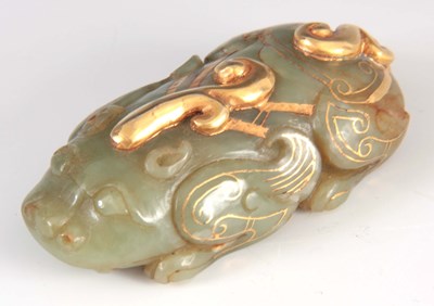 Lot 159 - A CHINESE JADE AND GILT SCULPTURE modelled as...