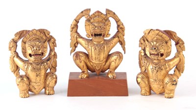 Lot 161 - THREE GILT CARVED ORIENTAL BUDDHAS 19cm high...