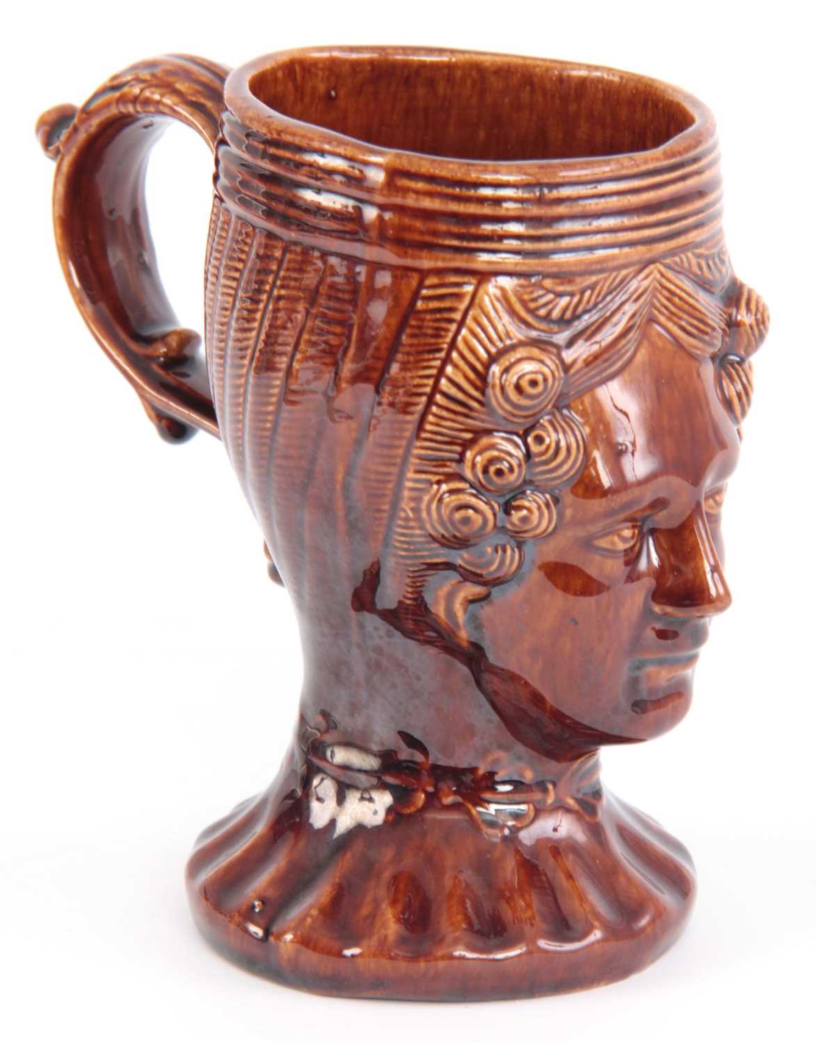 Lot 64 - A 19TH CENTURY TREACLE GLAZED POTTERY MUG...