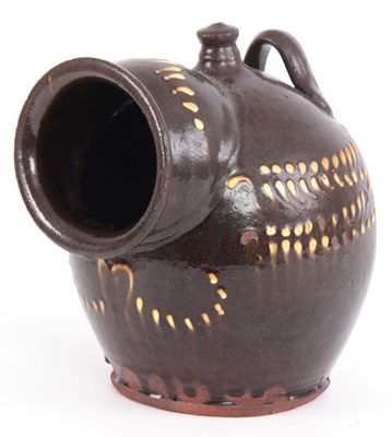 Lot 69 - A 19TH CENTURY SLIPWARE SALT PIG decorated...